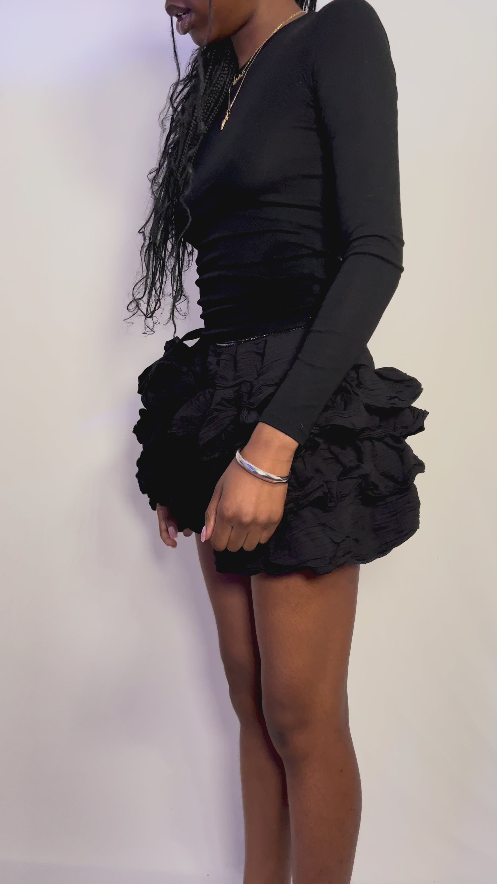 black mini ruffle skirt flattering and playful. Can be worn casually as street style and then elevated to an evening look.