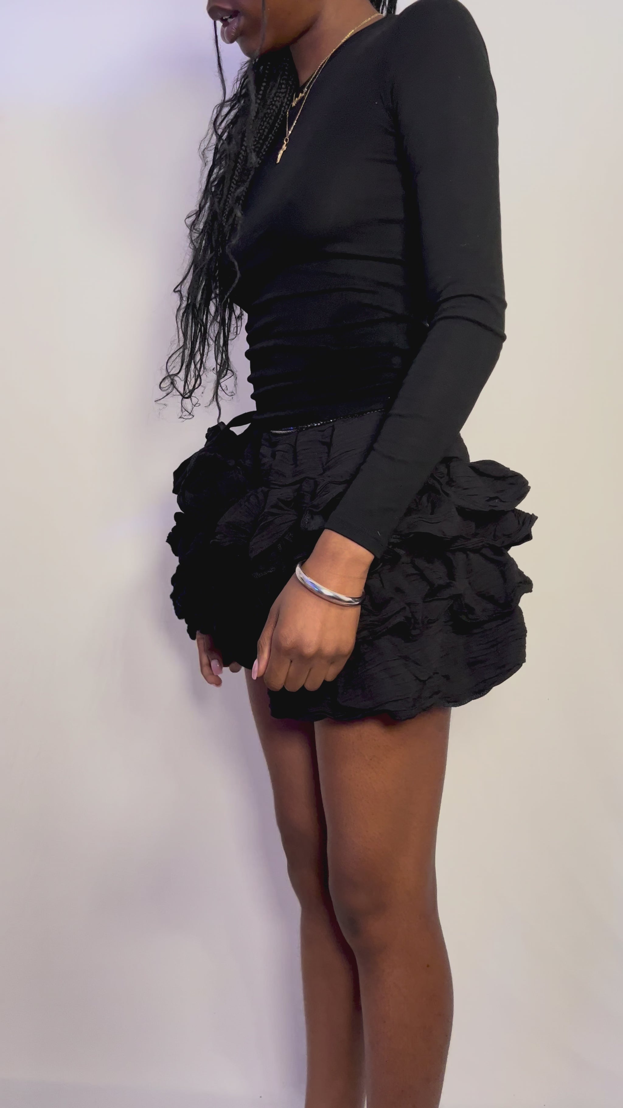 black mini ruffle skirt flattering and playful. Can be worn casually as street style and then elevated to an evening look.
